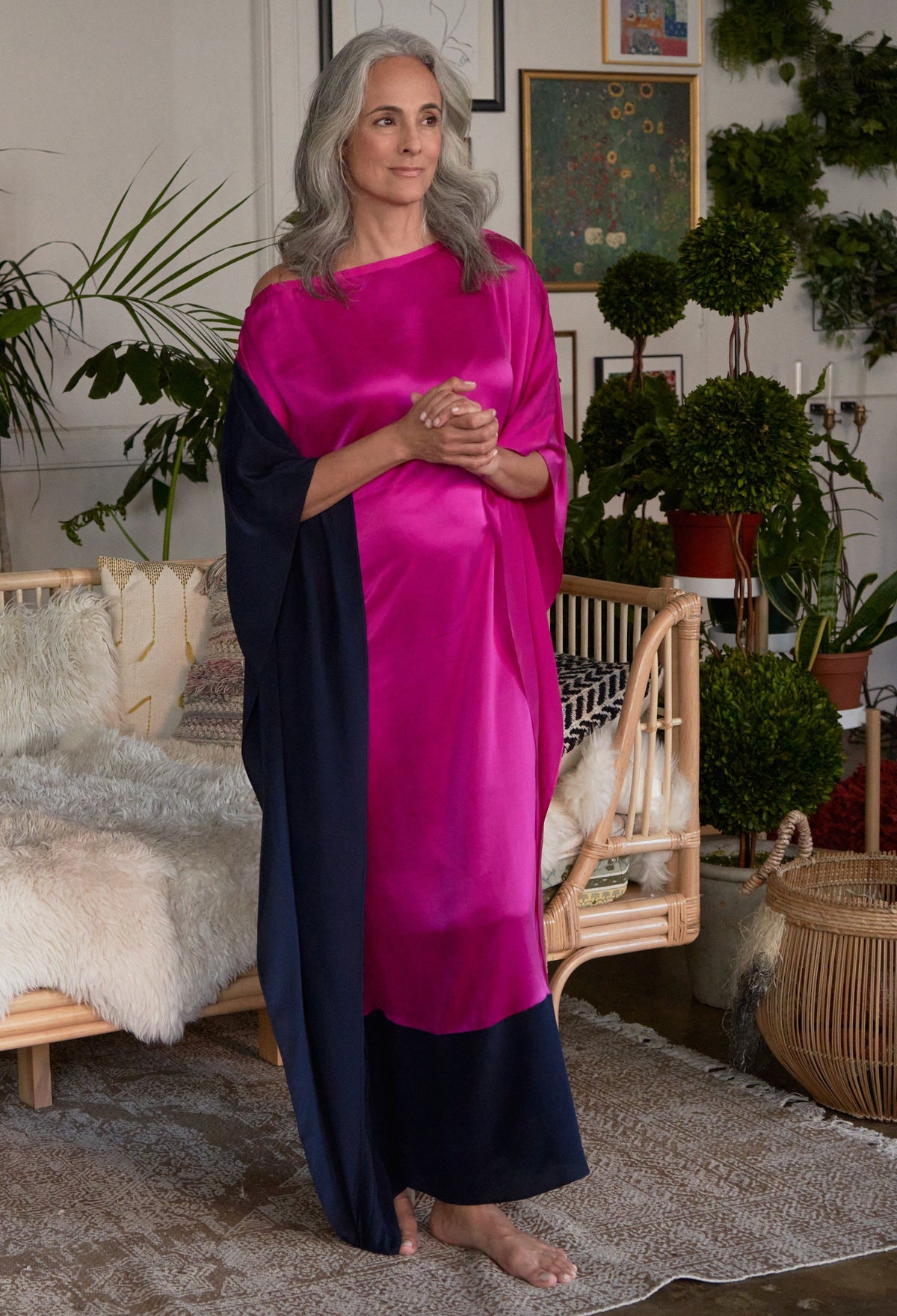 Woman with grey hair with her hands clasped wearing ocean+main Fuchsia And Navy Contrast Boatneck Silk Caftan